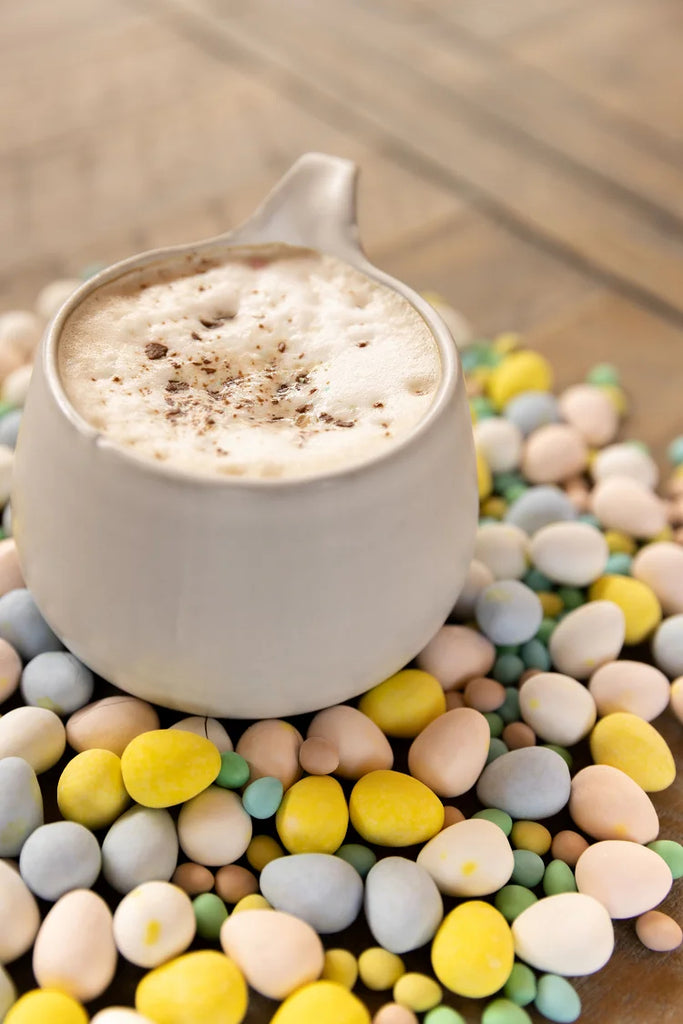 Coffee Alternative Latte surrounded by Mini Eggs, topped with chopped micro mini eggs