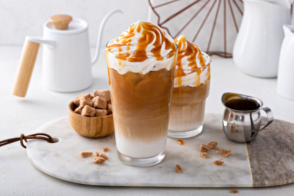 Salted Caramel Iced Caffeine-free coffee topped with whipped cream and caramel sauce, made with Nummy Creations Herbal Coffee alternative in Caramel flavour